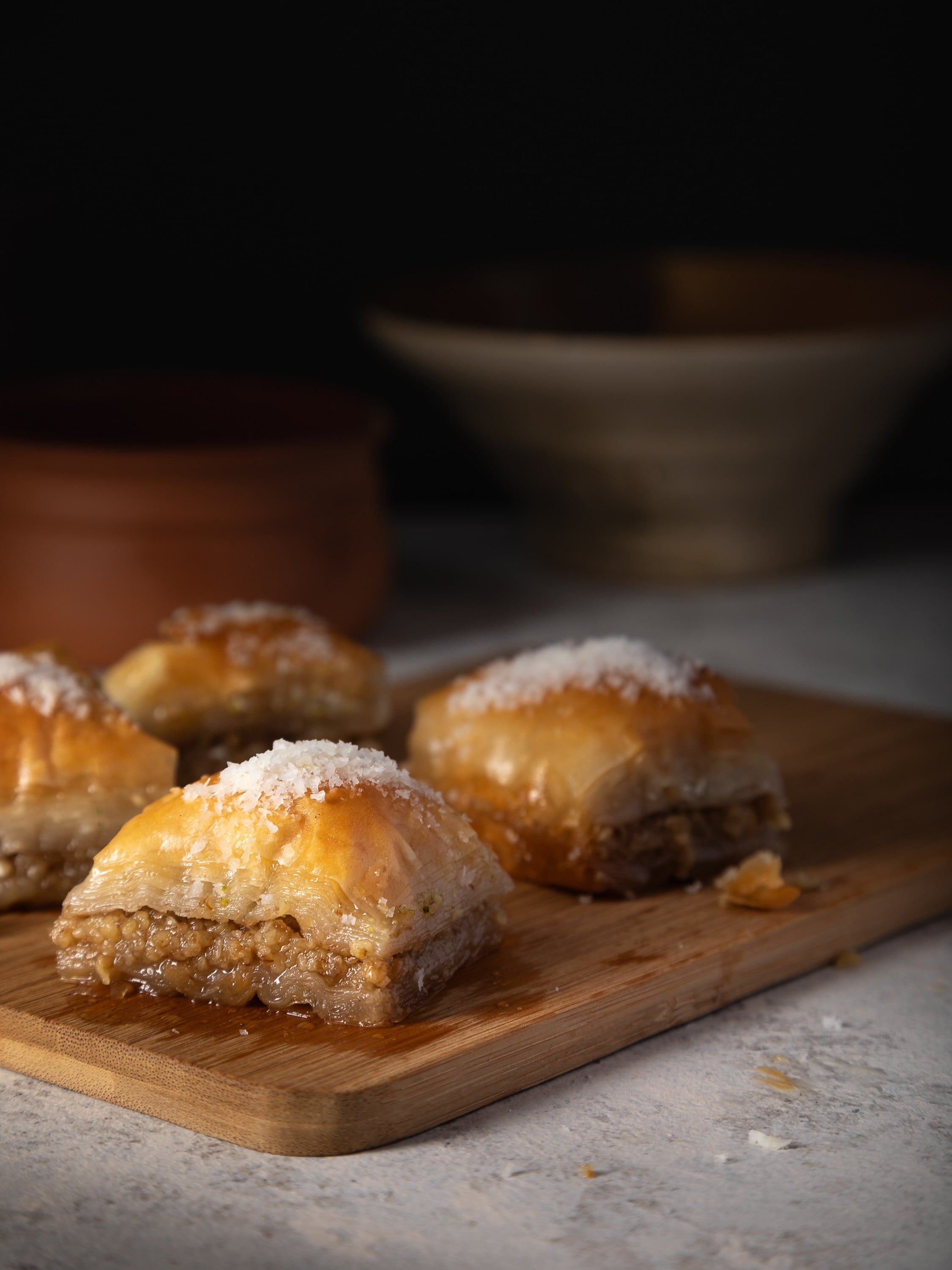 Sweet sticky baclava served on a board.