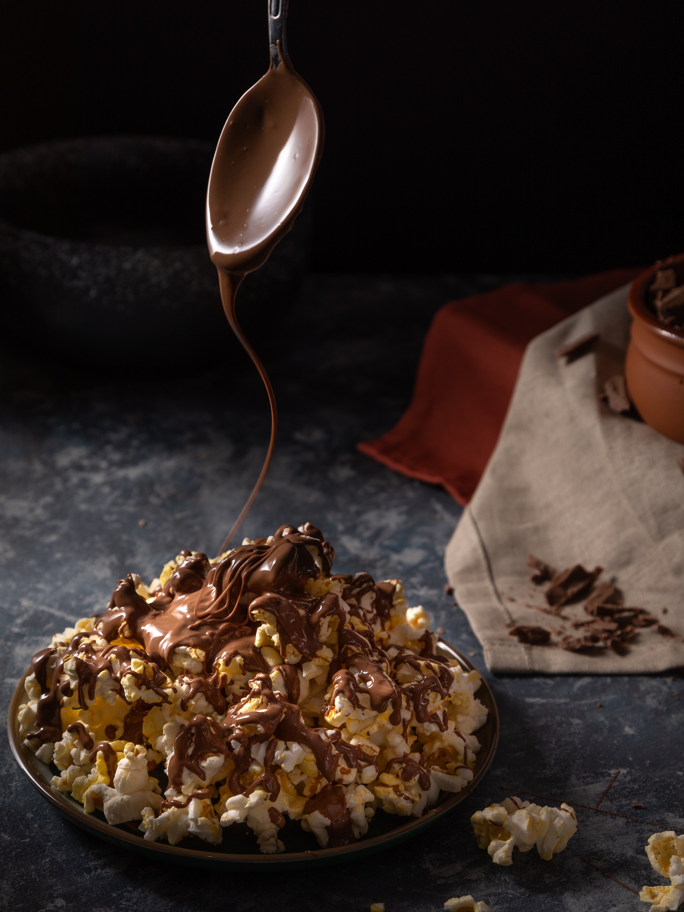 Freshly popped popcorn drizzled with milk chocolate for food photography project