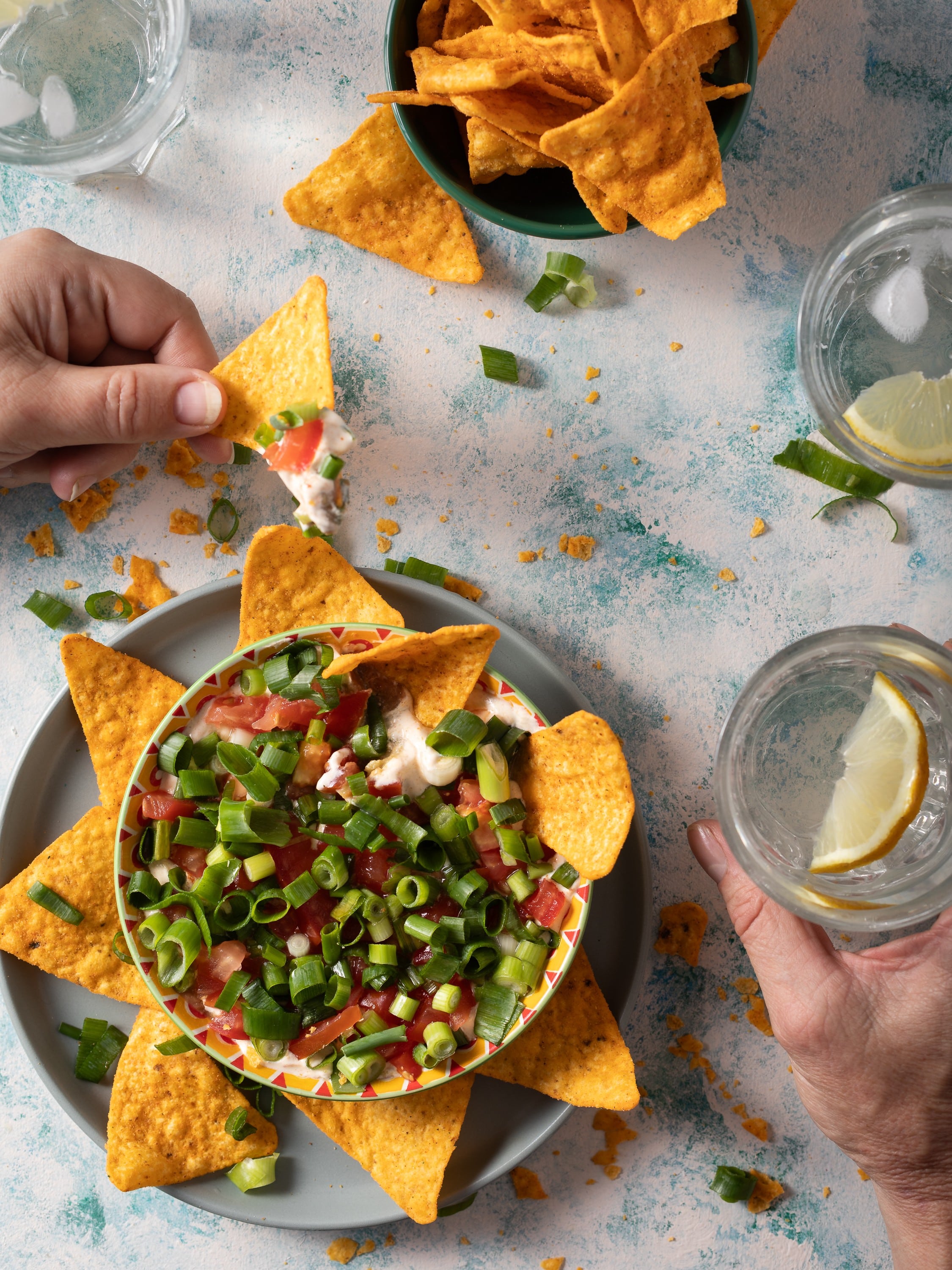 Mexican styled dip with cornchips and iced lemon water photographed by Steve Wickenton food photographer